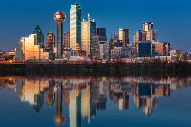 The classic Dallas, Texas skyline at dusk, with reflections in the Trinity River